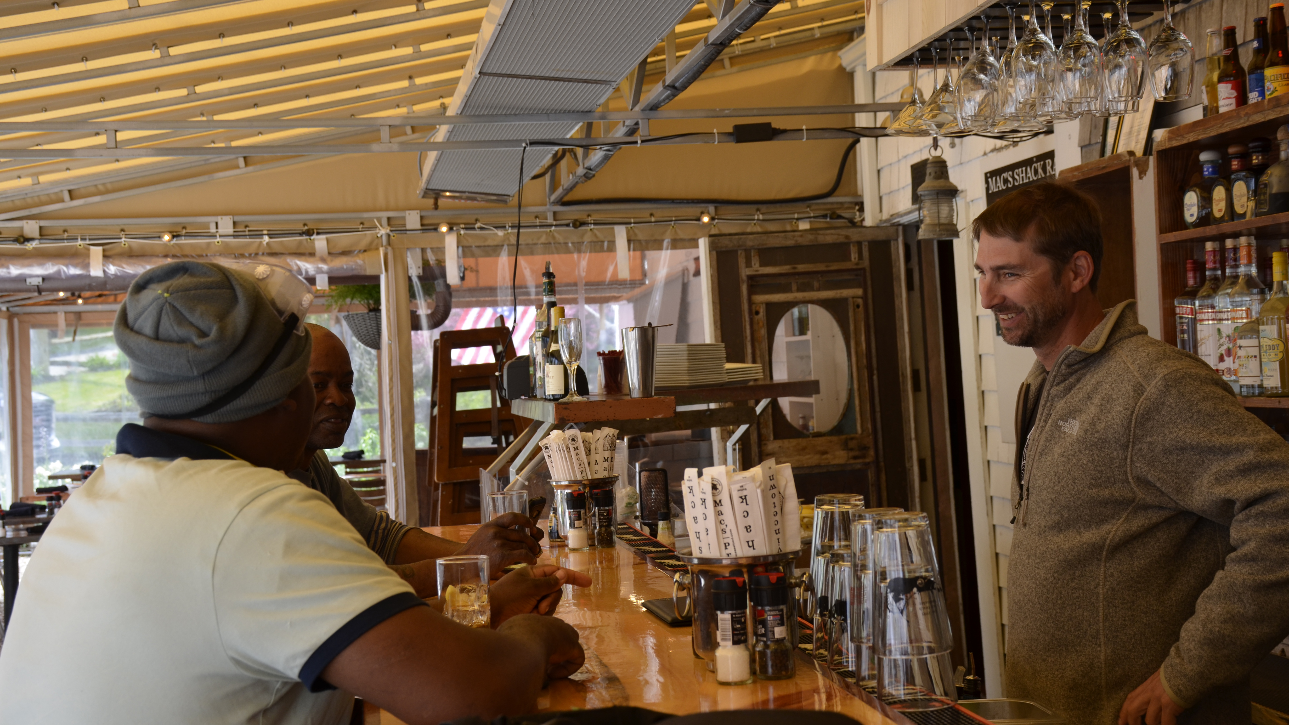 MacGregor “Mac” Hay speaks with some customers at Mac’s Shack in Wellfleet. Hay is entering his 23rd summer on the Cape running his popular Mac’s restaurants and markets. 